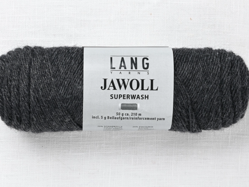 A skein of Timo sukka ohje fingerin ja Lang jawoll, dark gray fingering yarn, sits on a white textured surface. The 50g label includes 5g reinforcement yarn—ideal for any neulontaohje project or Timo sukka ohje.