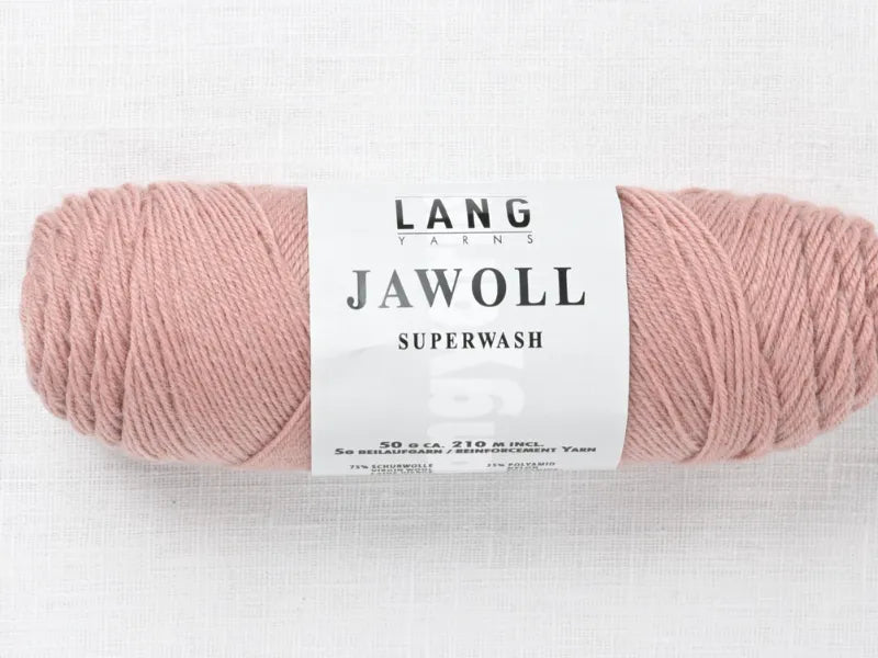A skein of Timo sukka ohje fingerin ja Lang jawoll yarn in soft pink rests on a white textured surface—ideal for knitting socks or your favorite patterns, with label detailing weight, length, and composition.