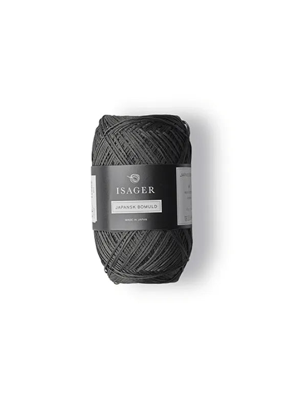 A skein of dark grey Isager Japansk Bomuld with a black and white wrapper, ideal for summer knits, is shown against a plain white background.