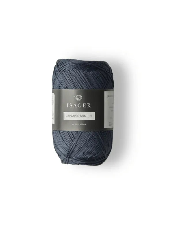 A dark blue skein of Isager Japansk Bomuld yarn with a gray and white label is displayed upright against a white background.