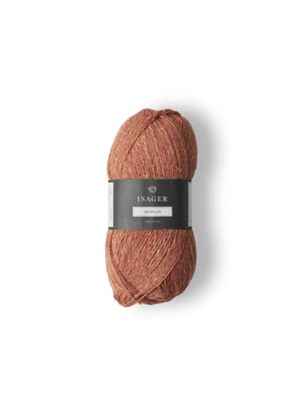 A skein of Isager Merlin yarn, a luxurious merino wool and linen blend in warm reddish-brown, is displayed on a white background. The skein has a black and white label with the brand name and product details.