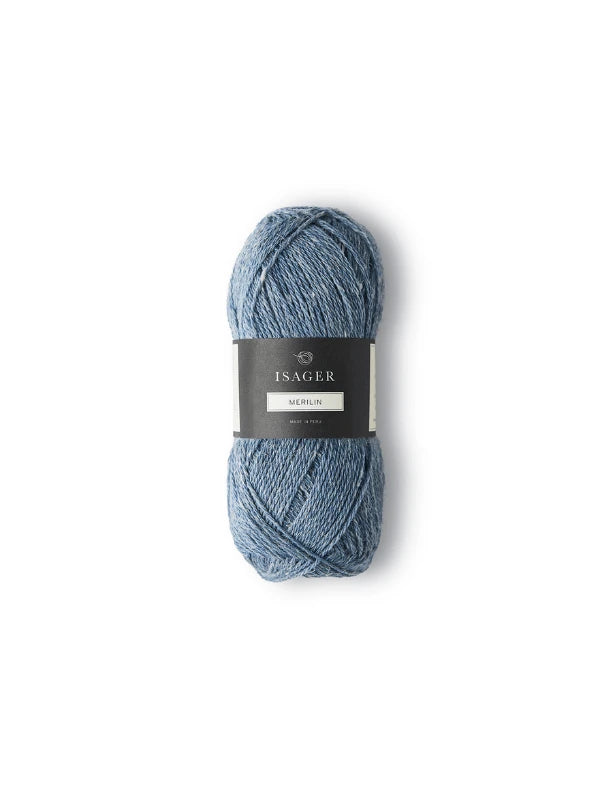 A skein of blue Isager Merlin yarn with a black and white label is shown against a plain white background.