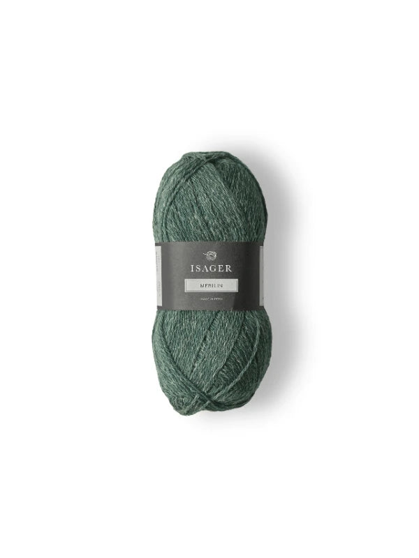 A skein of green Isager Merlin yarn with a gray label around the center, shown on a white background.