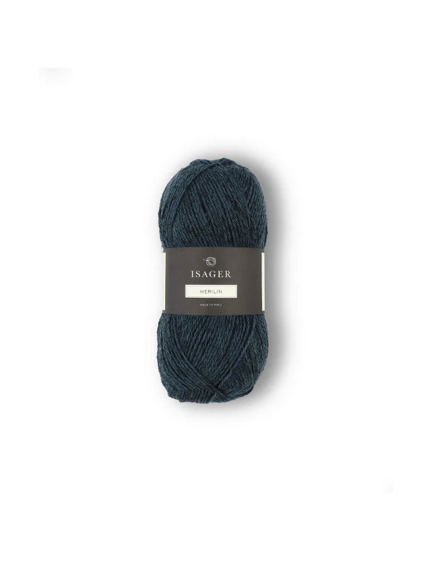 A skein of dark blue Isager Merlin yarn is shown against a white background, with a gray label that reads Isager Merlin.