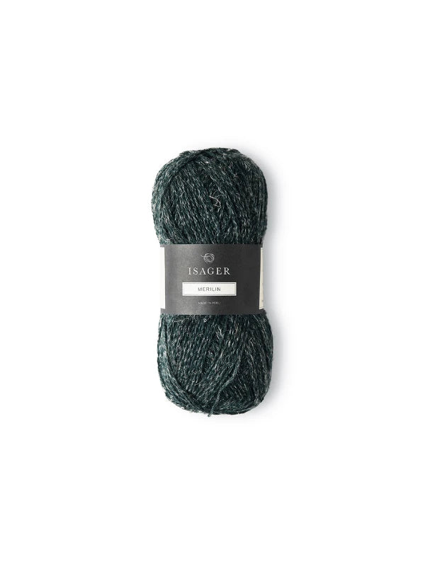 A skein of dark green Isager Merlin yarn with white flecks is shown against a plain white background.