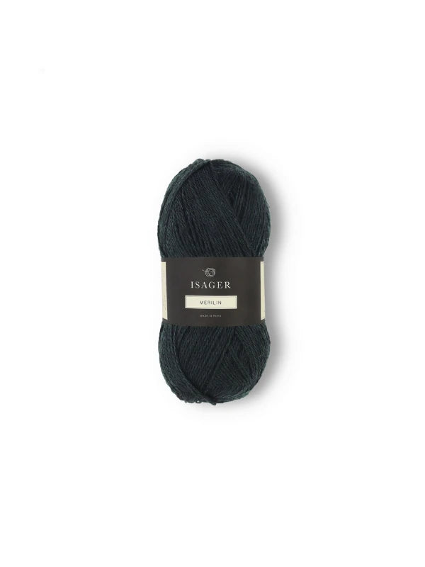 A dark green skein of Isager Merlin, wrapped with a black and cream label, displayed against a white background.