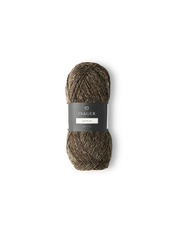 A skein of Isager Merlin brown and beige yarn with a black label wrapped around the middle, displayed on a plain white background.