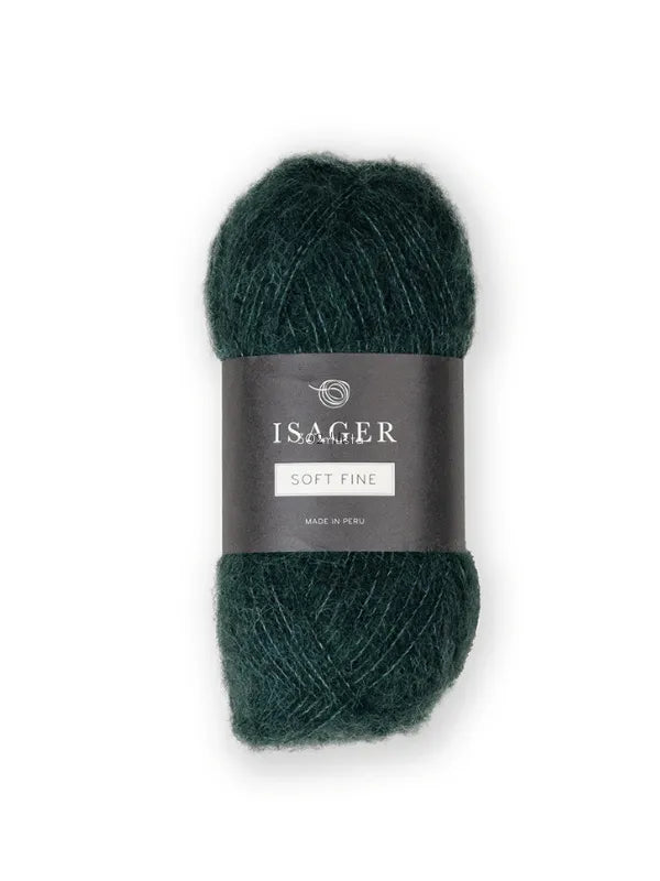 A skein of deep green Isager Soft Fine yarn with a black label around the middle, showing the brand name and lace-weight yarn details.