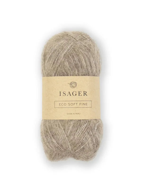 A skein of light brown Isager Soft Fine yarn with a beige paper label showing the brand name and details. The yarn has a fuzzy, soft texture and is displayed against a white background.
