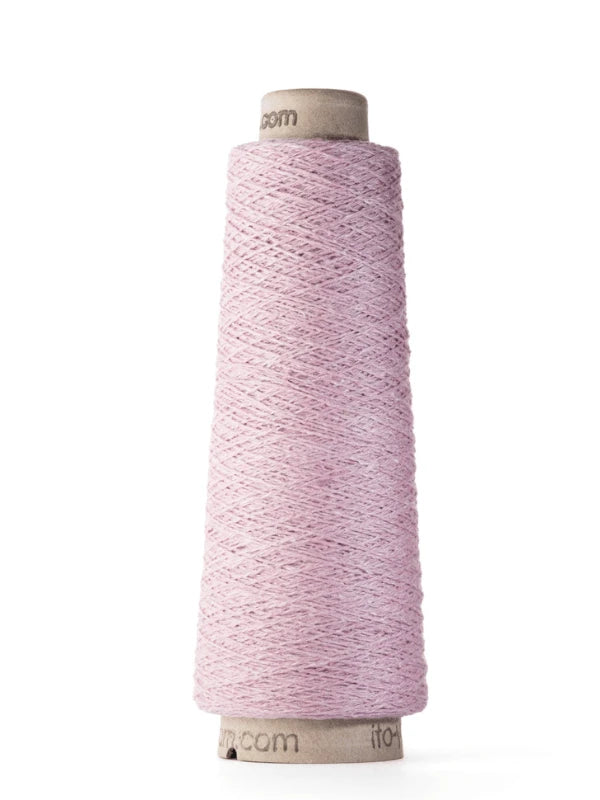 A spool of Ito Kinu in pale pink stands upright against a white background. This 100% silk thread is neatly wound around a tall, cone-shaped core—perfect for kesäneuleisiin projects.