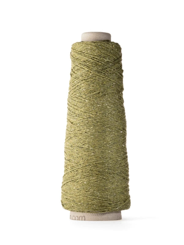 A spool of green Ito Kinu is tightly wound around a cone-shaped white cardboard holder, ideal for kesäneuleisiin, and photographed against a plain white background.
