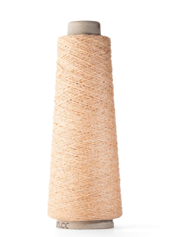 A tall spool of Ito Kinu in light tan stands upright against a white background. The 100% silk thread is neatly wound around the cone-shaped spool, perfect for kesäneuleisiin projects.