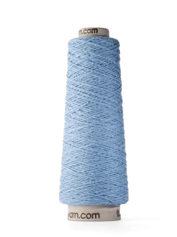 A tall cone of Ito Yarn Shimo in light blue is wound tightly around a cardboard core and stands upright against a white background, with the label partially visible at the top and bottom edges.
