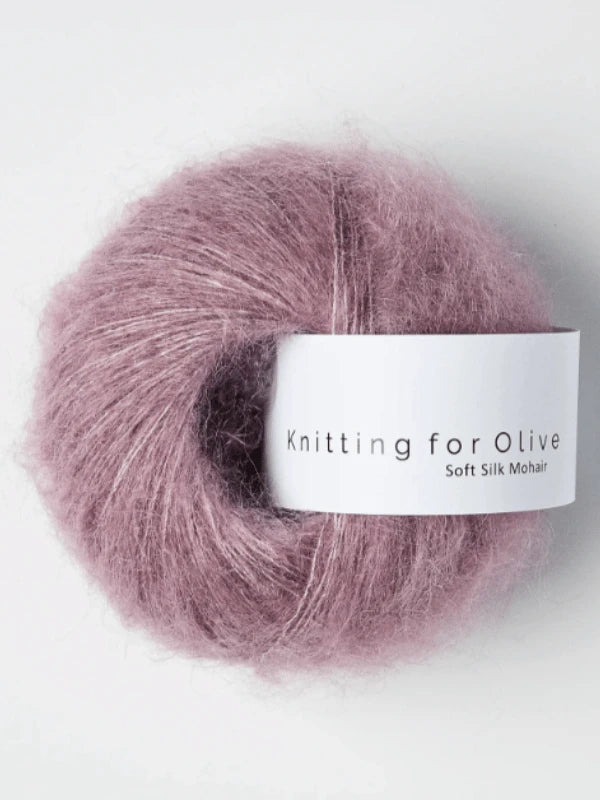 A ball of soft, fuzzy mauve yarn labeled "Knitting for Olive Soft Silk Mohair," made with kid mohair certified by the Responsible Mohair Standard, against a white background.