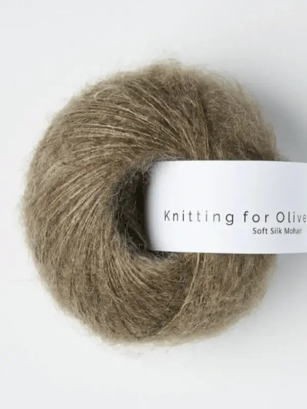 A ball of light brown, fuzzy Knitting for Olive Soft Silk Mohair yarn, spun from kid mohair that meets the Responsible Mohair Standard, set against a plain white background.