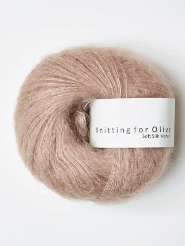 A ball of Knitting for Olive Soft Silk Mohair yarn in a light brown, fluffy texture rests on a white background.