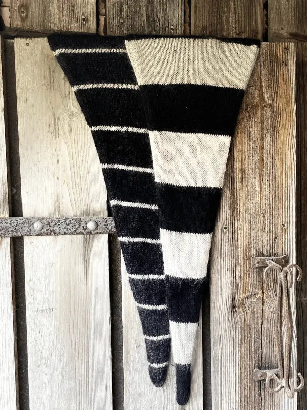 Two long, triangular scarves made from Knitting for Olive Merino and Soft Silk Mohair yarns—one with thin black-and-white stripes, the other with bold stripes—are shown using the Somany huivi ohje PDF pattern.