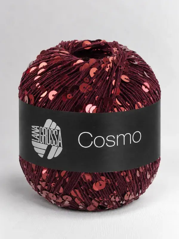 A ball of deep red Lana Grossa Cosmo yarn embellished with shiny, matching sequins.