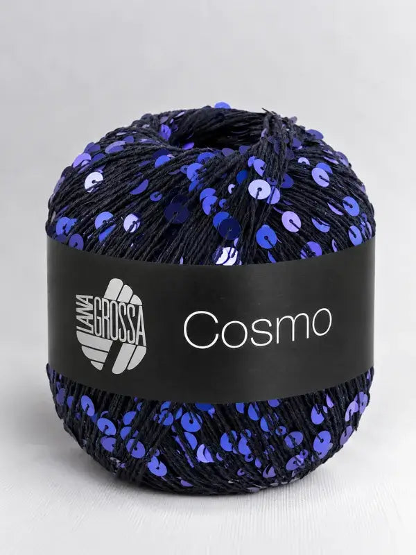 A ball of dark navy Lana Grossa Cosmo yarn covered in iridescent blue sequins.