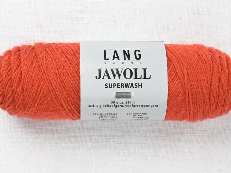 A skein of bright orange Lang Yarns Jawoll fingering weight yarn with a product label.
