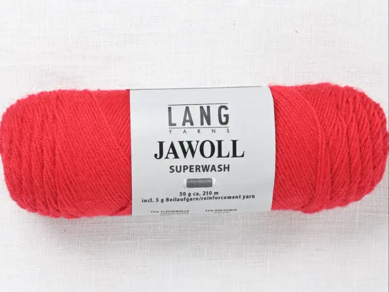 A skein of bright red Lang Yarns Jawoll fingering yarn with a label displaying product information.