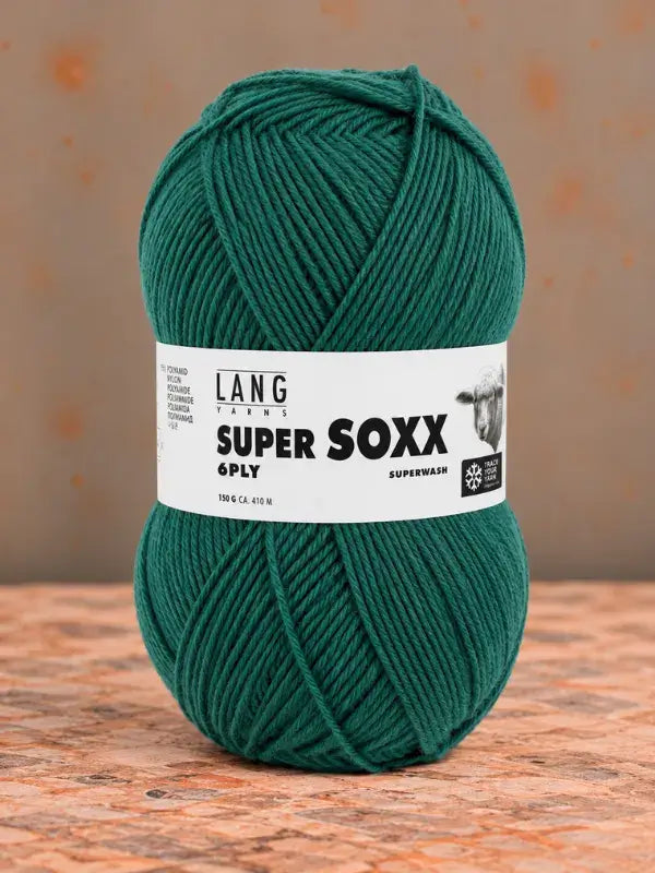 A ball of forest green Lang Yarns Super Soxx 6 ply – kestävä sukkalanka villasta with a product label featuring a sheep icon and text reading Super Soxx 6 Ply.