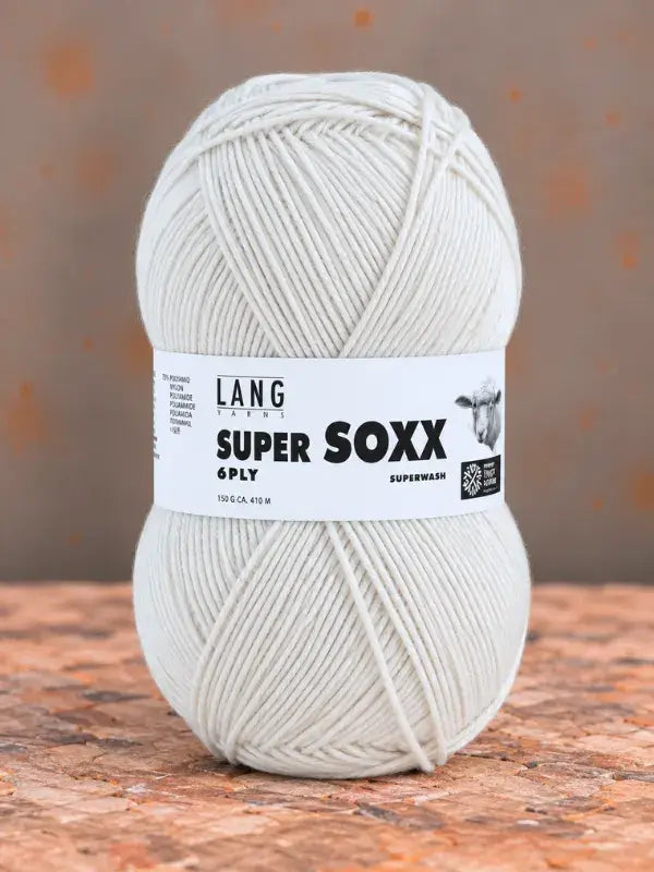 A ball of white Lang Yarns Super Soxx 6 ply – kestävä sukkalanka villasta yarn with a paper label.