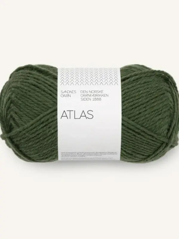 A skein of dark green Sandnes Garn Atlas yarn, made from soft norjalainen karitsanvilla, with additional text on a white label, set against a plain light background.
