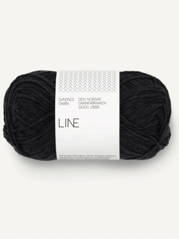 A skein of Sandnes Garn Line in black, labeled for the Elodie Tee knitting pattern (ENG), features a white and gray band with Norwegian text and a chevron design.