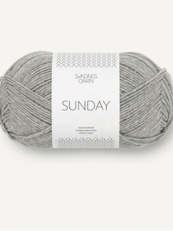 A skein of light grey Sandnes Garn Sunday merino wool, mulesing-free, with a white and grey label, shown against a plain light background.