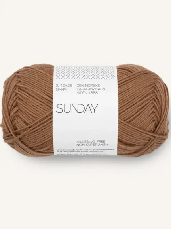 A skein of Sandnes Garn Sunday yarn in light brown merinovillalanka, featuring white packaging, mulesing-vapaa (mulesing-free), and non-superwash.
