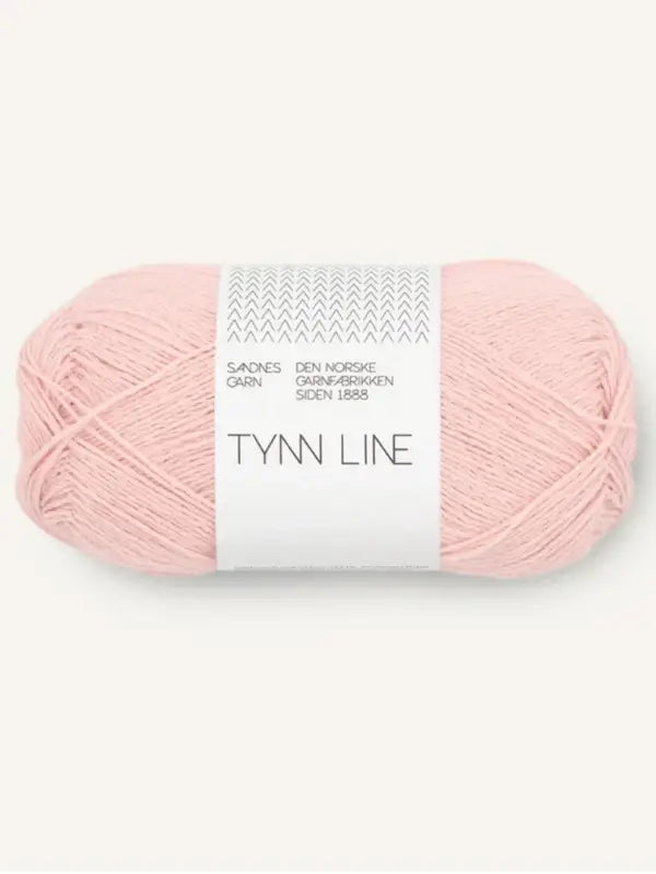 A skein of Sandnes Garn Tynn Line in light pink, a fingering-weight yarn perfect for summer knits, wrapped with a white label with geometric designs and Norwegian text, shown against a plain light background.
