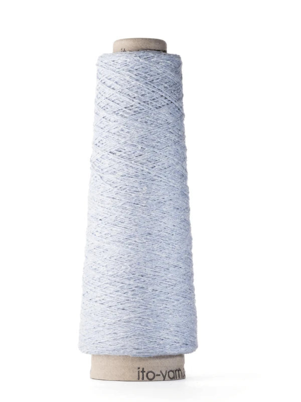 A cone of Ito Kinu in light blue, crafted from 100% silk, is wound on a cardboard spool and stands upright on a white background—ideal for kesäneuleisiin.