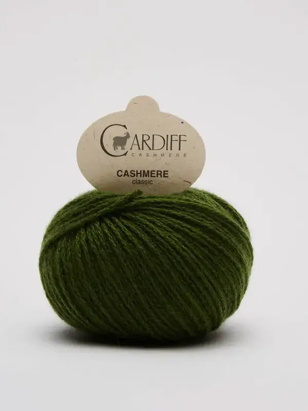A ball of green Cardiff Cashmere Classic – 100% kashmirlanka yarn with a cardboard label, set against a plain white background.