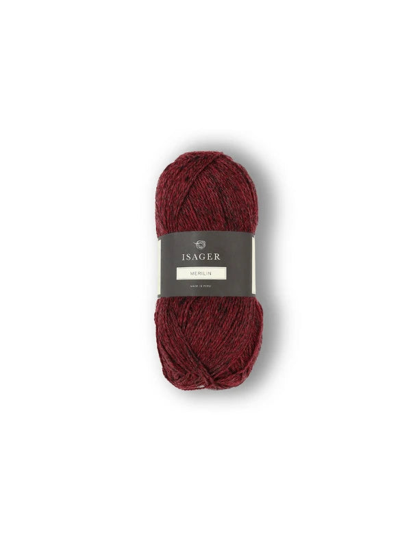 A skein of deep red Isager Merlin yarn rests against a plain white background.
