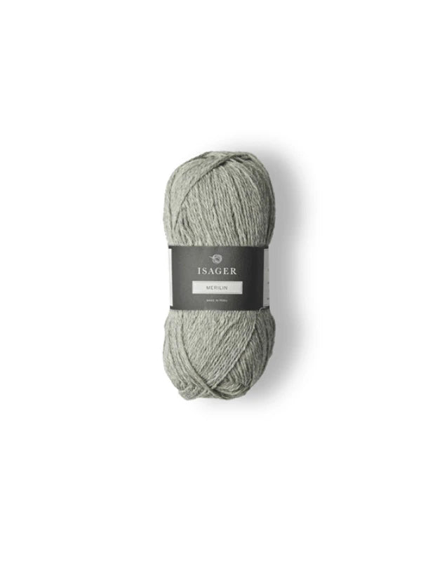 A skein of light gray-green Isager Merlin yarn with a black and white label is displayed on a white background.