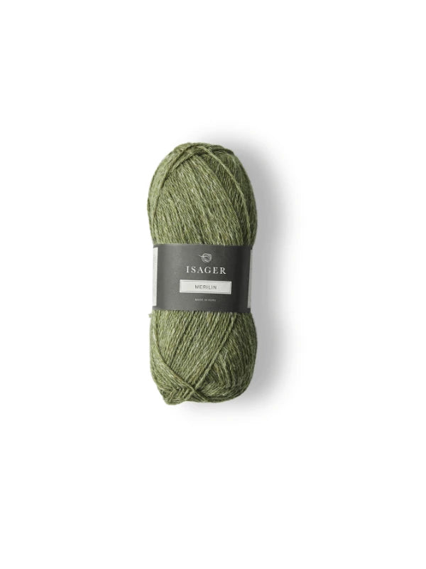 A skein of green Isager Merlin yarn with a black and gray label is displayed on a white background.