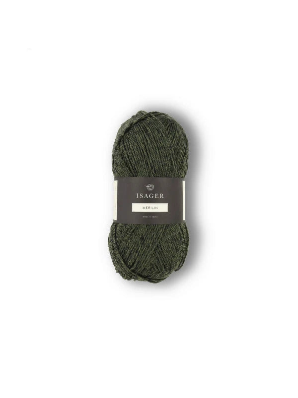 A skein of Isager Merlin dark green merinovillalanka yarn is shown against a plain white background, with its label visible.