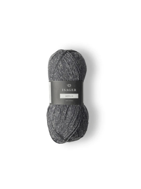 A skein of Isager Merlin in dark gray heathered merino wool blend rests on a white background, its label visible.