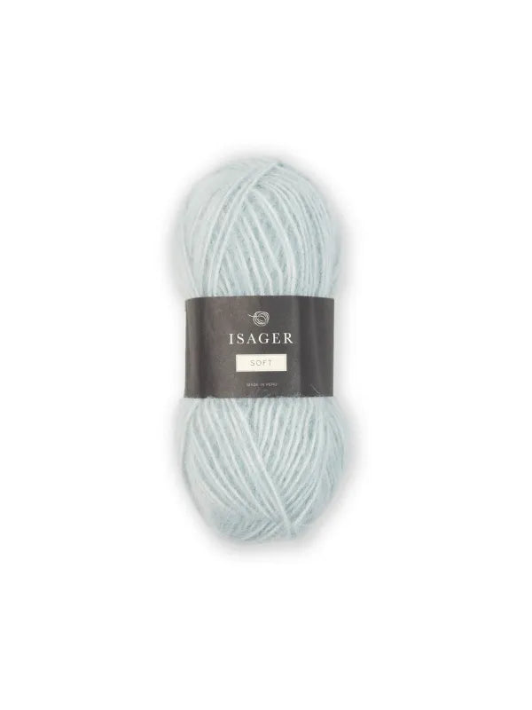 A skein of pale blue Isager Soft yarn with a black and gray label wrapped around the center, shown on a white background.