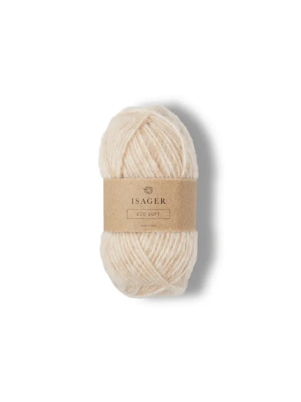 A ball of soft, off-white Isager Soft yarn, ideal as pehmeä neulelanka or alpakka lanka, is wrapped in a brown paper band and placed on a plain white background.