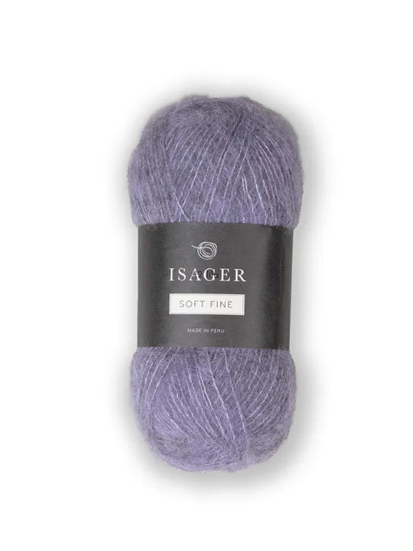 A skein of Isager Soft Fine yarn, soft and fine in purple, with a black label featuring the brand name and "Soft Fine, Made in Peru," sits on a white background. This is an alpaca silkki lanka.