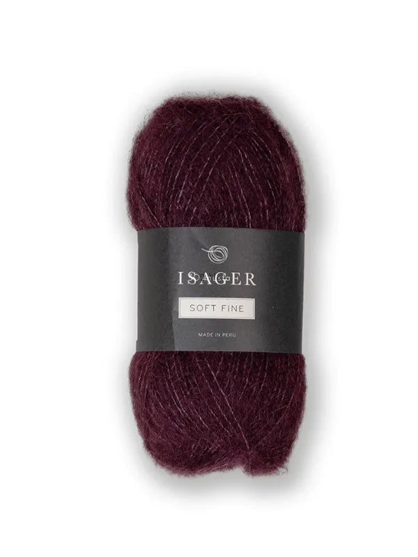 A skein of Isager Soft Fine in deep burgundy, featuring a black and white center band, is displayed against a plain white background.