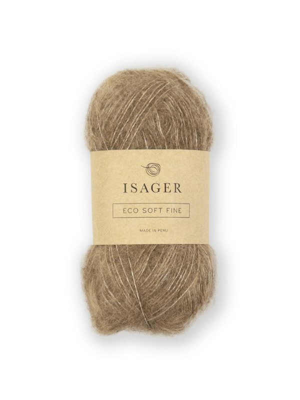A skein of light brown Isager Soft Fine yarn with a beige Eco Soft Fine label bearing text and a circular logo is displayed against a white background.
