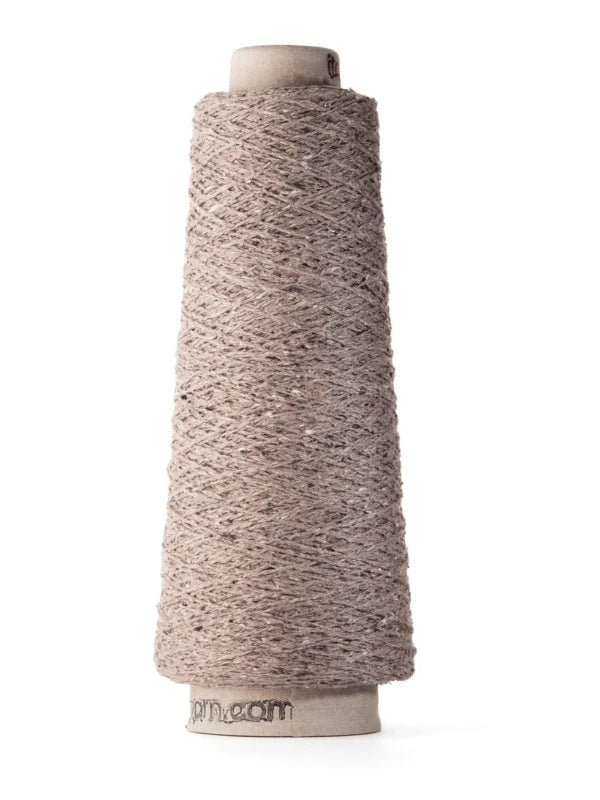 A tall, cone-shaped spool of Ito Kinu light brown textured japanilainen silkkilanka, made from 100% silkki and wound on a cardboard core, stands upright on a white background—perfect for kesäneuleisiin.