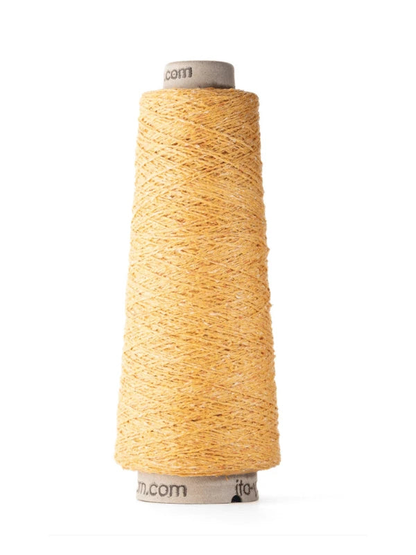 A tall spool of golden yellow Ito Kinu, tightly wound in a conical shape, stands upright on a white background—ideal for kesäneuleisiin thanks to its luxurious 100% silkki composition.