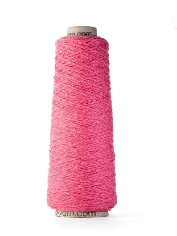 A tall spool of Ito Yarn Shimo in bright pink stands upright against a white background, with the yarn neatly wound around a cardboard cone.