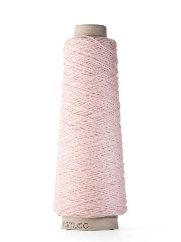 A spool of pale pink Ito Yarn Shimo, crafted from merinovilla lanka and kierrätetty silkki, is neatly wound around a cardboard cone and stands upright on a plain white background.