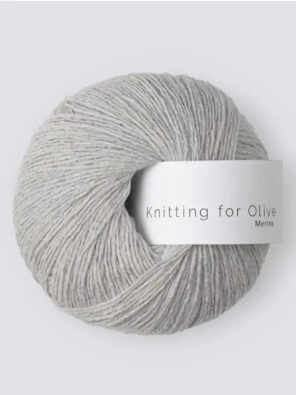 A light gray ball of Knitting for Olive Merino yarn with a white label, set against a plain light background.