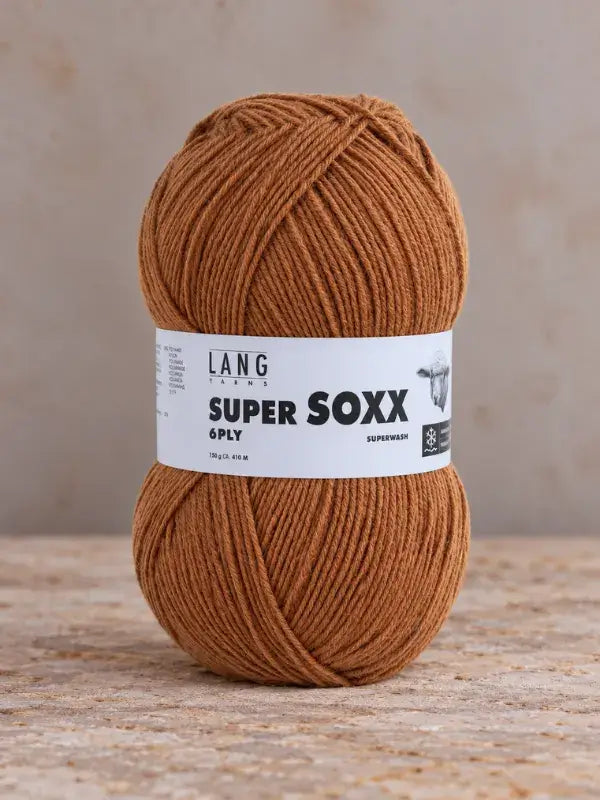 A ball of solid brown Lang Yarns Super Soxx 6 ply – kestävä sukkalanka villasta yarn with a white label.